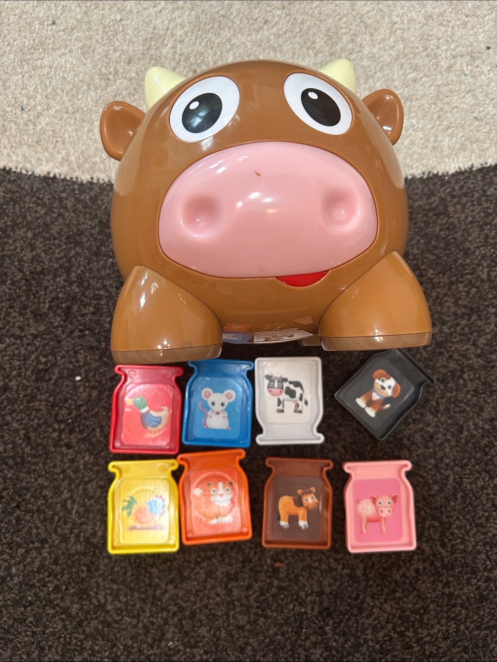 Interactive Brown Cow Toy with Pink Snout and Colorful Animal Blocks